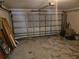 Spacious garage with an open door, storage, and space for two cars at 6203 Calamari Pl, Riverview, FL 33578