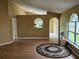Open-concept living room with modern flooring, arched doorways, and neutral walls at 6203 Calamari Pl, Riverview, FL 33578