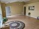 Open-concept living room with modern flooring, arched doorways, and neutral walls at 6203 Calamari Pl, Riverview, FL 33578
