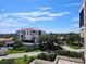 Balcony view of condo buildings, lush trees and a glimpse of the blue sky at 6218 Palma Del Mar S Blvd # 503, St Petersburg, FL 33715