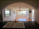 View from the kitchen, looking into the expansive living area with tile floors and a decorative chandelier at 6218 Palma Del Mar S Blvd # 503, St Petersburg, FL 33715