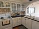 Updated kitchen features white cabinets, tile backsplash, and modern appliances at 6218 Palma Del Mar S Blvd # 503, St Petersburg, FL 33715