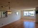 Bright living room with tile flooring, decorative chandelier, and a large window with a view at 6218 Palma Del Mar S Blvd # 503, St Petersburg, FL 33715