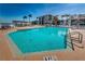 Relaxing swimming pool with plenty of lounge chairs and palm trees with blue skies at 6218 Palma Del Mar S Blvd # 503, St Petersburg, FL 33715
