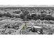 An aerial view of a residential neighborhood, highlighting a home with a pool and fenced-in yard at 6417 Willow Wood Ln, Tampa, FL 33634