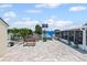 A beautiful backyard space with brick pavers, a basketball hoop, and bench seating at 6417 Willow Wood Ln, Tampa, FL 33634