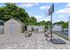 Relaxing backyard area featuring two benches, storage shed, and basketball hoop for recreational activities at 6417 Willow Wood Ln, Tampa, FL 33634