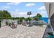 Outdoor space with brick pavers, basketball hoop, bench, and grape vines at 6417 Willow Wood Ln, Tampa, FL 33634
