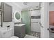 Bathroom featuring single sink vanity and tiled walk-in shower with sliding glass door at 6417 Willow Wood Ln, Tampa, FL 33634