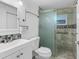 Bathroom featuring single sink vanity and tiled walk-in shower with glass door at 6417 Willow Wood Ln, Tampa, FL 33634