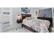 Bedroom with floral bedspread and wood furnishings next to a tiled walk-in shower at 6417 Willow Wood Ln, Tampa, FL 33634