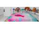 Bedroom with bright pink bedspread and an assortment of stuffed animals at 6417 Willow Wood Ln, Tampa, FL 33634