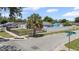 Corner lot home featuring a fenced yard, mature palm tree, and well-maintained landscaping at 6417 Willow Wood Ln, Tampa, FL 33634