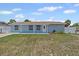 Charming single-story home featuring a well-maintained lawn, trimmed shrubs, and private driveway at 6417 Willow Wood Ln, Tampa, FL 33634