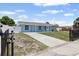 Charming single-story home featuring a well-maintained yard, fenced perimeter, and private driveway at 6417 Willow Wood Ln, Tampa, FL 33634