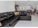 Inviting living room with a comfortable leather sectional sofa adjacent to a dining area at 6417 Willow Wood Ln, Tampa, FL 33634