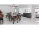 Open concept living and dining area with white tiled floors and modern furnishings at 6417 Willow Wood Ln, Tampa, FL 33634