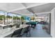 Screened-in sunroom with a pool table, dining table, and exercise equipment at 6417 Willow Wood Ln, Tampa, FL 33634
