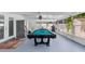 Bright sunroom featuring a pool table with french doors and a stainless steel refrigerator at 6417 Willow Wood Ln, Tampa, FL 33634