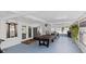 Bright sunroom with a pool table, ceiling fan, and backyard views at 6417 Willow Wood Ln, Tampa, FL 33634