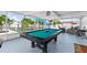 Sunroom with a billiards table and a glimpse of the surrounding landscape at 6417 Willow Wood Ln, Tampa, FL 33634