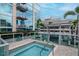 Relaxing hot tub next to pool area with outdoor kitchen, lounge chairs, and modern building backdrop at 777 N Ashley Dr # 2513, Tampa, FL 33602