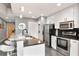 Fully equipped kitchen featuring stainless steel appliances, tile backsplash, and breakfast bar area at 777 N Ashley Dr # 2513, Tampa, FL 33602