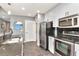 Contemporary kitchen featuring stainless steel appliances, tile backsplash, and functional layout at 777 N Ashley Dr # 2513, Tampa, FL 33602