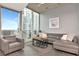 Bright living room with floor-to-ceiling windows, a comfortable seating area, and city views at 777 N Ashley Dr # 2513, Tampa, FL 33602