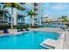 Resort-style swimming pool features lounge chairs, palm trees, and a modern high-rise backdrop at 777 N Ashley Dr # 2513, Tampa, FL 33602