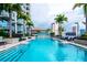 Beautiful swimming pool lined with palm trees, providing a refreshing escape with city views and comfortable loungers at 777 N Ashley Dr # 2513, Tampa, FL 33602