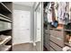 A well-organized walk-in closet featuring custom shelves, drawers, and mirrored doors for a modern storage solution at 777 N Ashley Dr # 2513, Tampa, FL 33602