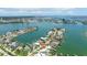 Stunning aerial view of waterfront homes, featuring private boat docks and serene water views on a sunny day at 7892 10Th S Ave, St Petersburg, FL 33707