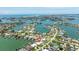 Captivating aerial view of a waterfront property showcasing the community's canal system and surrounding residential areas at 7892 10Th S Ave, St Petersburg, FL 33707