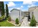 Charming backyard shed with stone pathway, complemented by lush greenery and a cozy atmosphere at 7892 10Th S Ave, St Petersburg, FL 33707