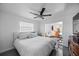 This bright bedroom features a ceiling fan, modern decor, polished floors, and access to outdoor areas at 7892 10Th S Ave, St Petersburg, FL 33707