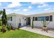 Inviting front entrance features a walkway, manicured landscaping, and a well-maintained exterior at 7892 10Th S Ave, St Petersburg, FL 33707
