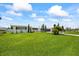 Charming single-story home featuring a well-maintained lawn, mature trees, and a welcoming facade at 7892 10Th S Ave, St Petersburg, FL 33707