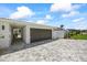 Spacious garage with a paved driveway, providing ample parking and curb appeal to the property at 7892 10Th S Ave, St Petersburg, FL 33707