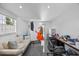 Versatile room with an art studio, comfortable seating, gray tile flooring and ample natural light at 7892 10Th S Ave, St Petersburg, FL 33707
