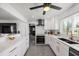 Modern kitchen features white cabinets, stainless appliances and ample counter space at 7892 10Th S Ave, St Petersburg, FL 33707