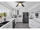 Modern kitchen features white cabinets, stainless appliances and ample counter space at 7892 10Th S Ave, St Petersburg, FL 33707