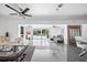 Open-concept living room with tile flooring, modern decor, and pool view at 7892 10Th S Ave, St Petersburg, FL 33707