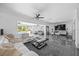 The combined living and dining area is bright, has modern furniture, and large glass doors overlooking the pool at 7892 10Th S Ave, St Petersburg, FL 33707
