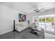 Bright living room with sleek tile floors, modern decor and view of backyard pool at 7892 10Th S Ave, St Petersburg, FL 33707