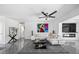Stylish living room with sleek gray tile flooring, modern decor, and a contemporary ceiling fan at 7892 10Th S Ave, St Petersburg, FL 33707