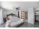 Bright primary bedroom featuring a sliding barn door, modern ceiling fan, and ensuite bath access at 7892 10Th S Ave, St Petersburg, FL 33707