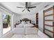 Spacious main bedroom features a plush bed and sliding glass doors leading to the outdoor patio at 7892 10Th S Ave, St Petersburg, FL 33707