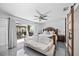 Bright main bedroom with an outside view, ceiling fan, polished tile flooring and a stylish white sofa at 7892 10Th S Ave, St Petersburg, FL 33707
