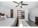 This modern main bedroom features a stylish sliding barn door, a ceiling fan, and elegant decor at 7892 10Th S Ave, St Petersburg, FL 33707